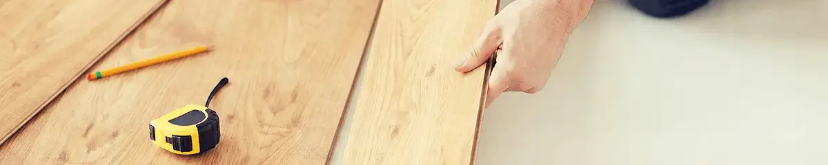 A professional installing wood flooring in Baton Rouge, LA