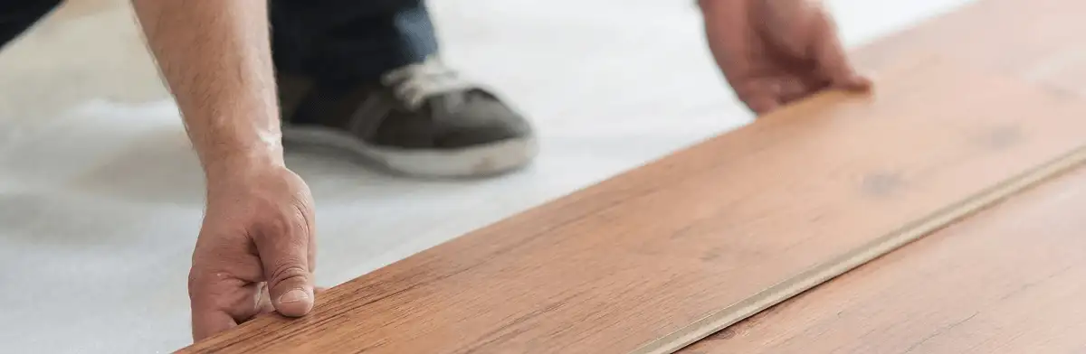 A professional installing laminate flooring in Baton Rouge, LA