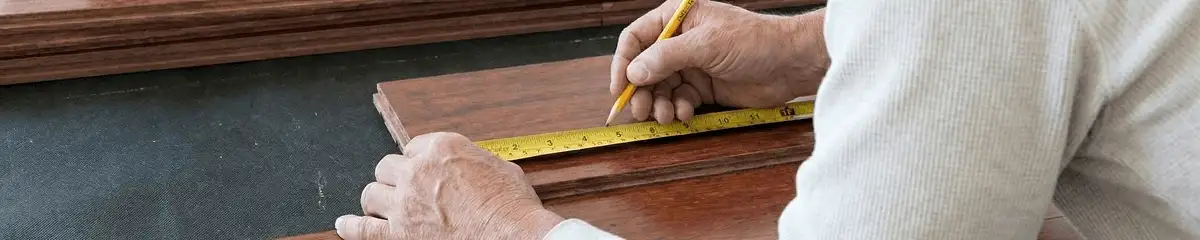 A professional installing wood flooring in Baton Rouge, LA